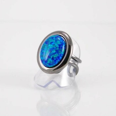 Bague fini gunmetal et imitation opale bleu...